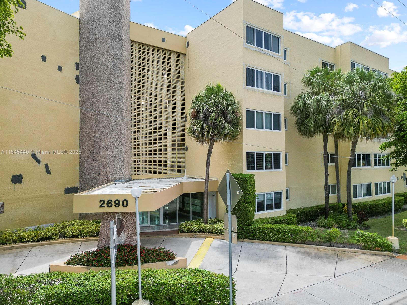 2690 Southwest 22nd Avenue, Unit 507 Miami, FL 33133 - Photo 1 of 20 a front view of a building with garden