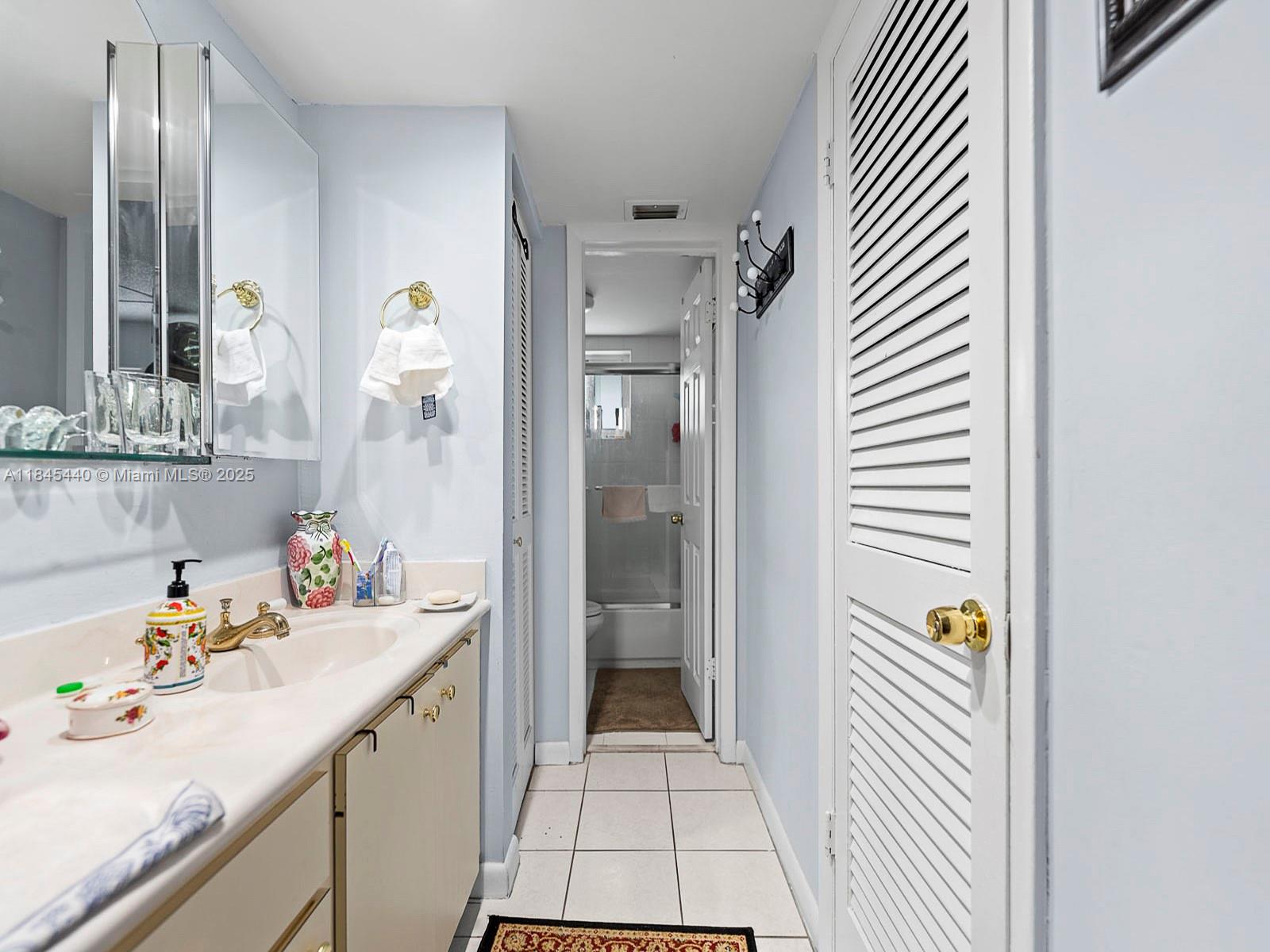 2690 Southwest 22nd Avenue, Unit 507 Miami, FL 33133 - Photo 12 of 20 a bathroom with a sink and mirror