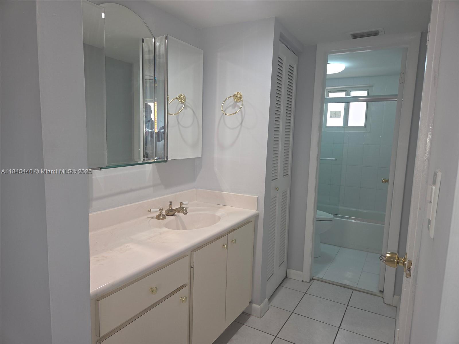2690 Southwest 22nd Avenue, Unit 507 Miami, FL 33133 - Photo 14 of 20 a bathroom with a sink and a mirror