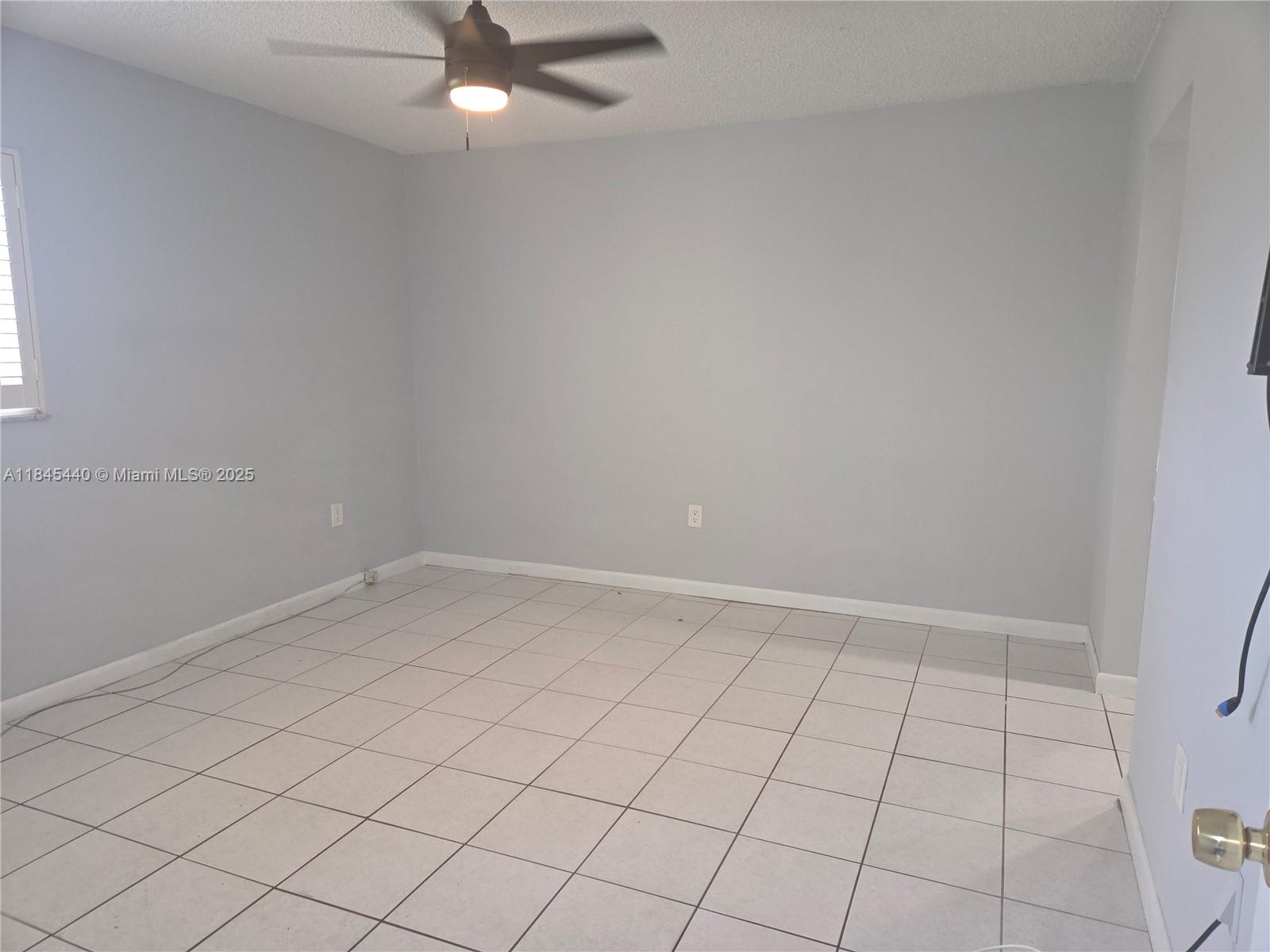 2690 Southwest 22nd Avenue, Unit 507 Miami, FL 33133 - Photo 15 of 20 an empty room and chandelier fan