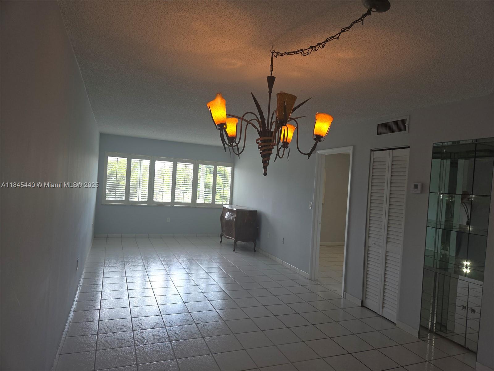 2690 Southwest 22nd Avenue, Unit 507 Miami, FL 33133 - Photo 16 of 20 wooden floor in an empty room with a window