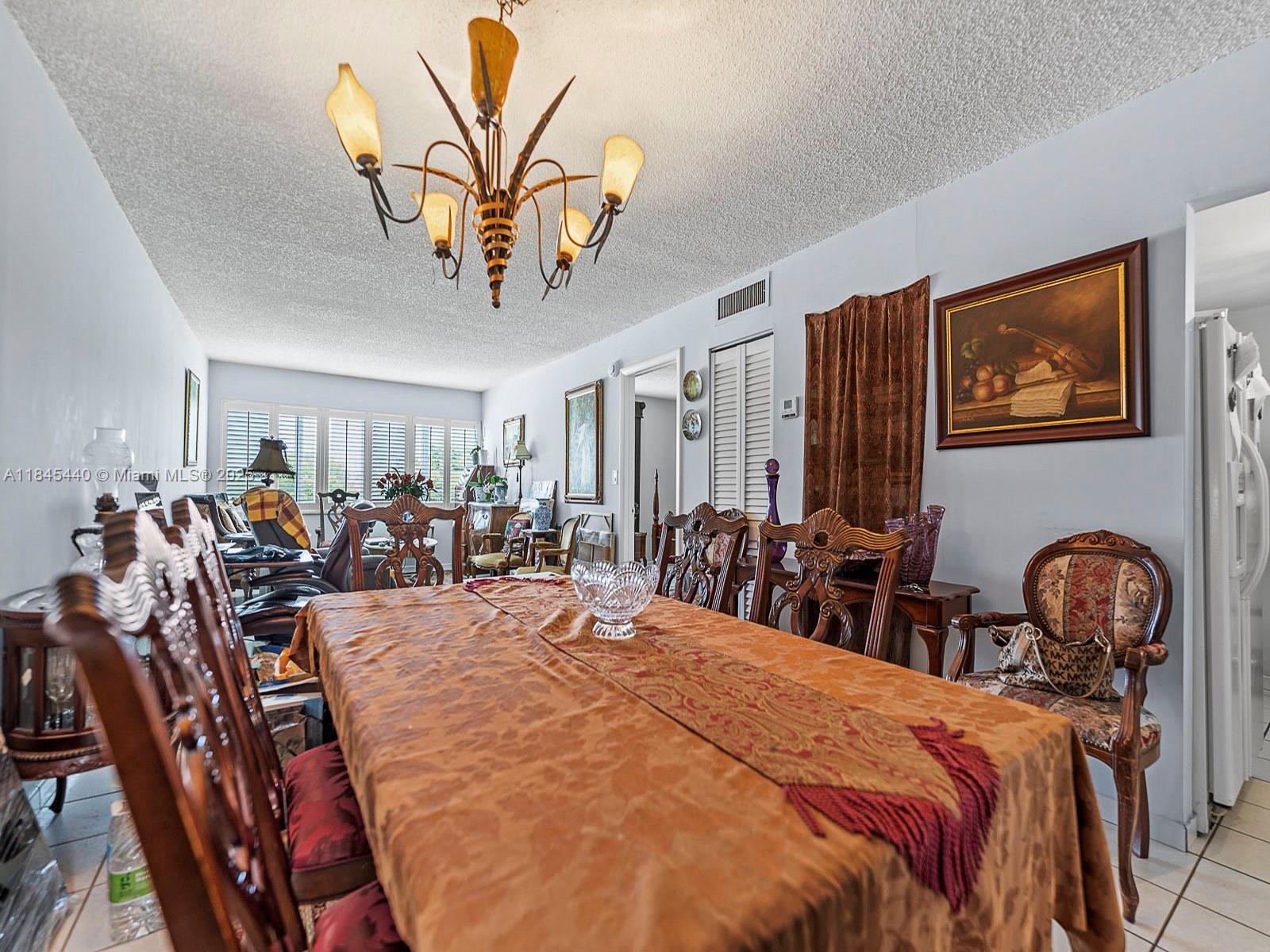 2690 Southwest 22nd Avenue, Unit 507 Miami, FL 33133 - Photo 4 of 20 a bed room with furniture a chandelier and a window