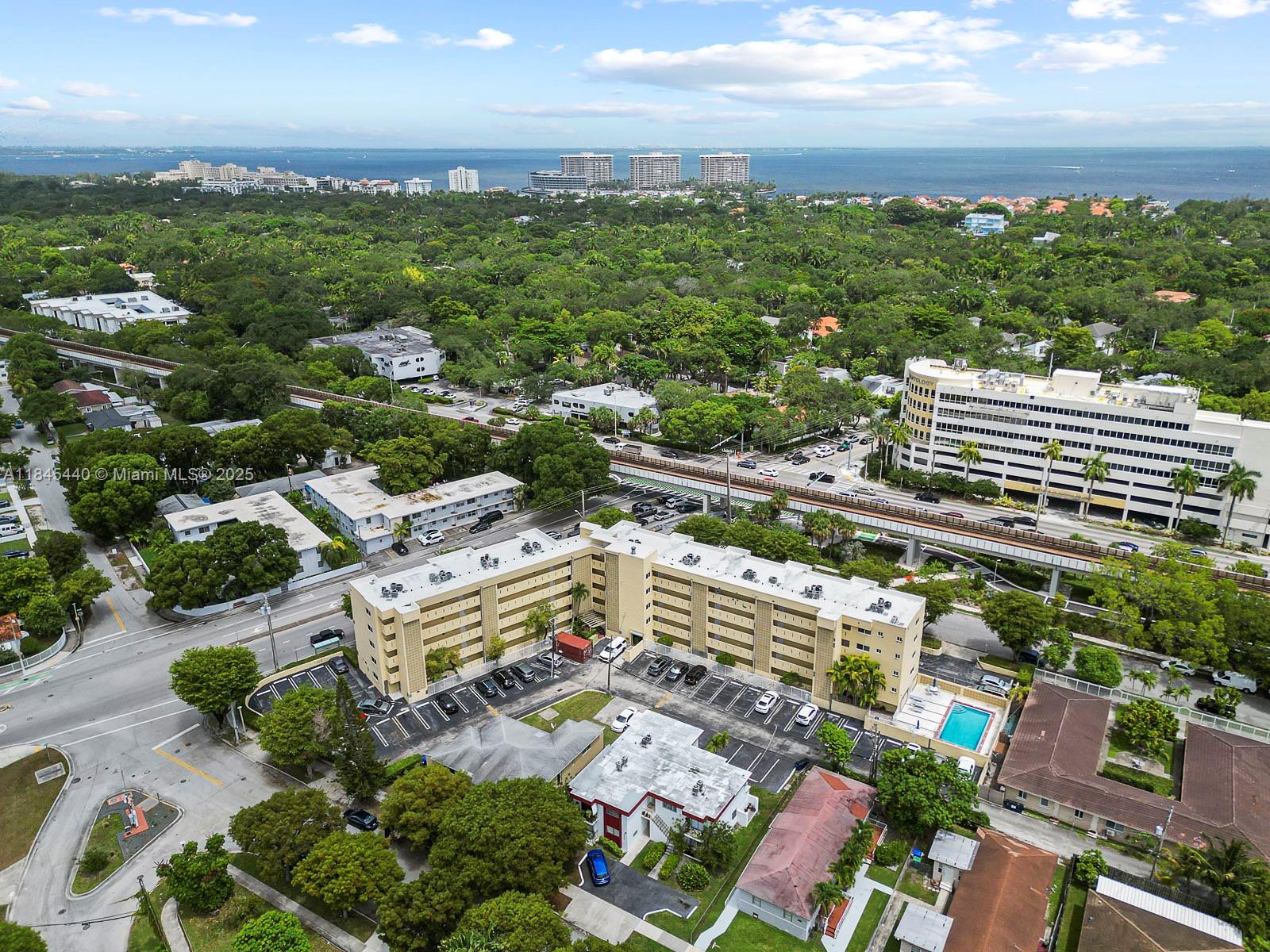 2690 Southwest 22nd Avenue, Unit 507 Miami, FL 33133 - Photo 8 of 20 an aerial view of a city with lots of residential buildings ocean and mountain view in back