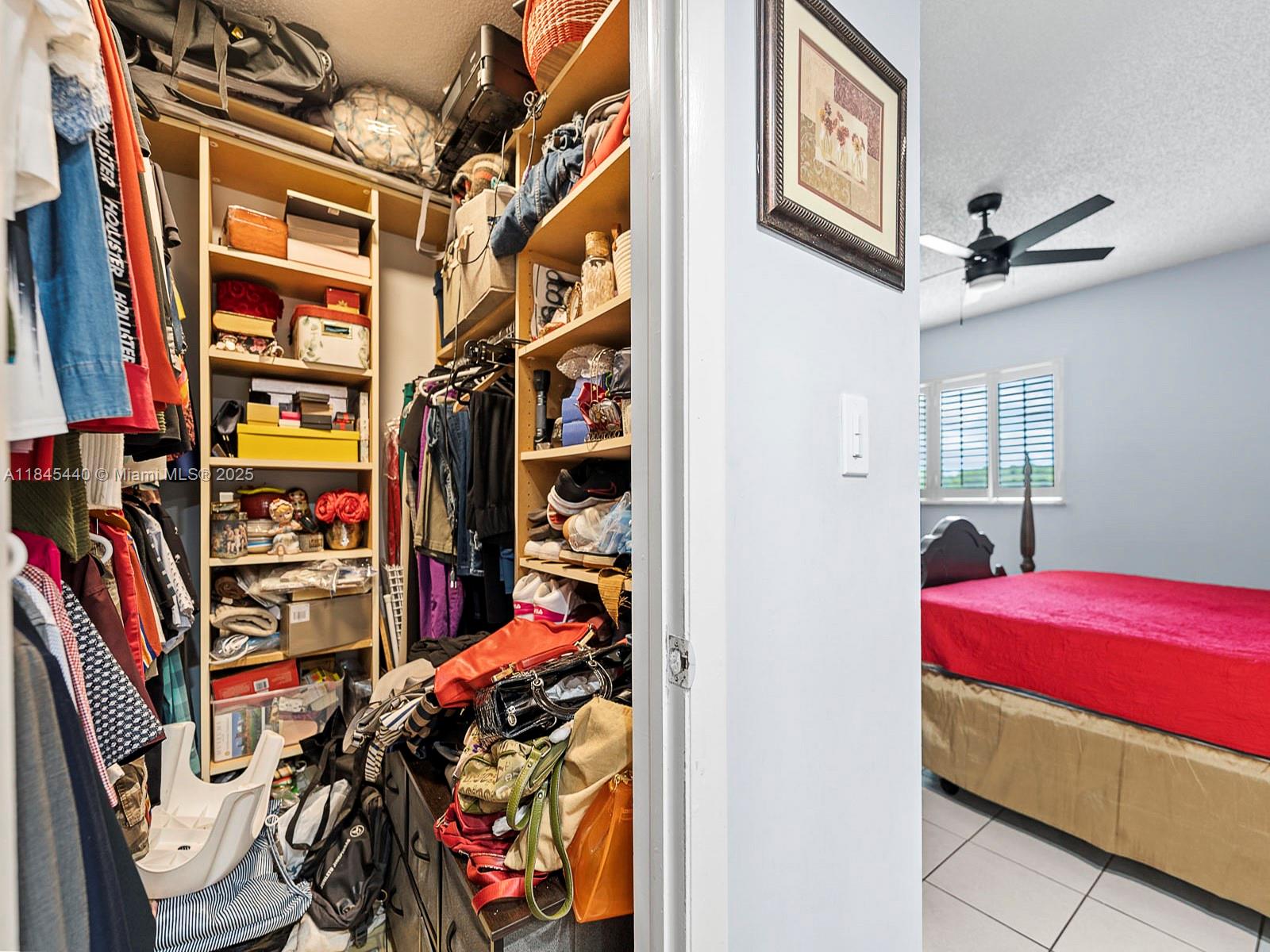 2690 Southwest 22nd Avenue, Unit 507 Miami, FL 33133 - Photo 10 of 20 a view of walk in closet with clothes and shoes