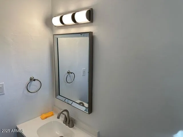 a bathroom with a sink and mirror
