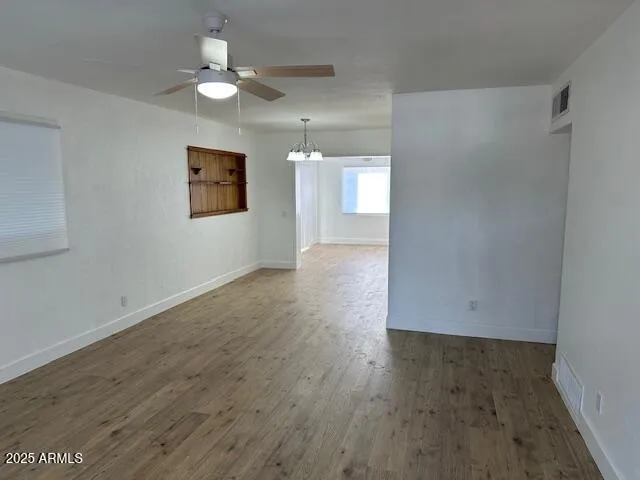 wooden floor in an empty room with a window