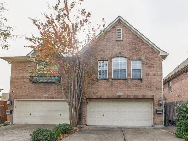 a front view of a house with garage