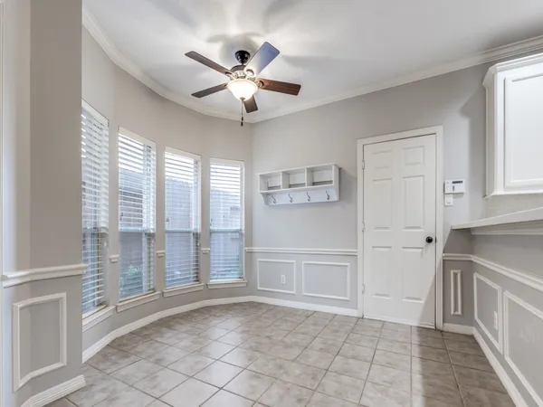 a view of a livingroom with a chandelier fan and windows