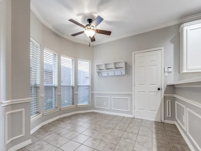 a view of a livingroom with a chandelier fan and windows