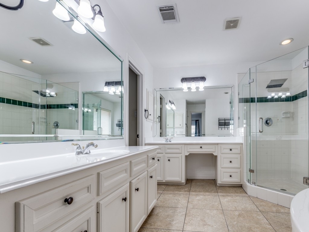 5413 Nolda Street Houston, TX 77007 - Photo 17 of 25 a spacious bathroom with a sink a large mirror and a shower