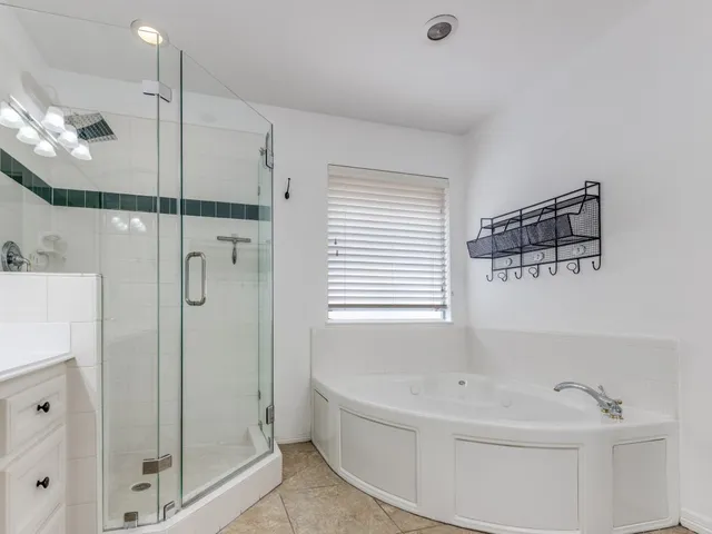 a bathroom with a bathtub and a shower