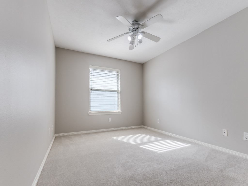 5413 Nolda Street Houston, TX 77007 - Photo 19 of 25 an empty room with a chandelier fan and windows