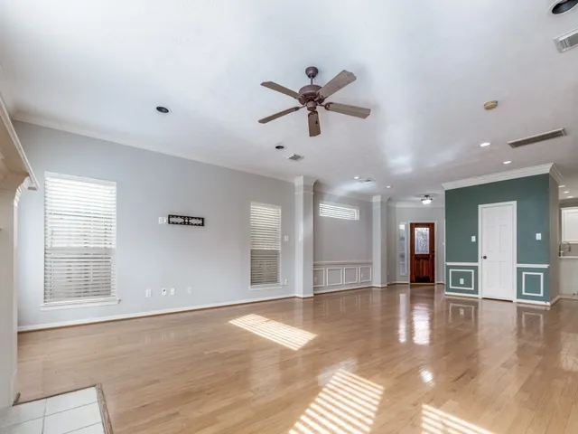 a view of a livingroom with a ceiling fan and window