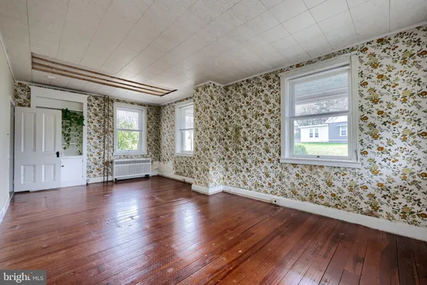 wooden floor in an empty room with a window