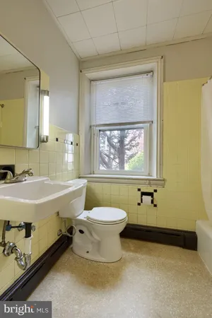 an empty room with entrance and windows