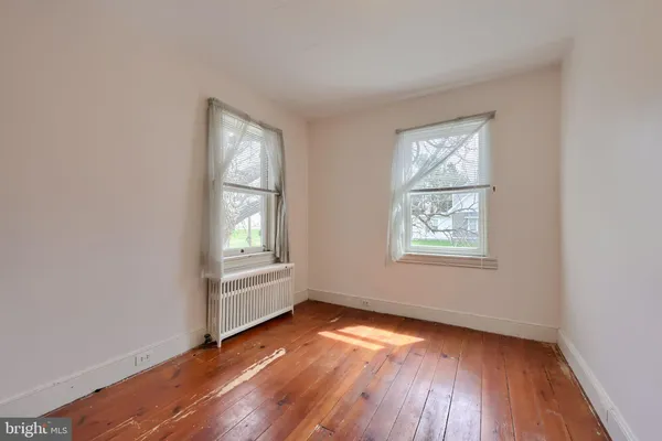 a view of an empty room with wooden ceiling