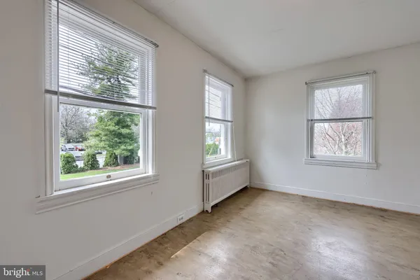 a backyard of a house with lots of green space and fountain