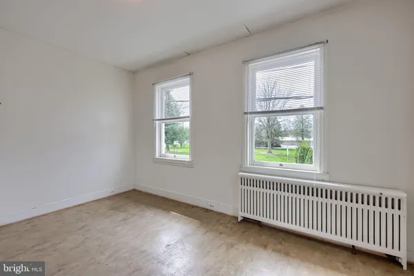 a view of a house with a large tree and a yard