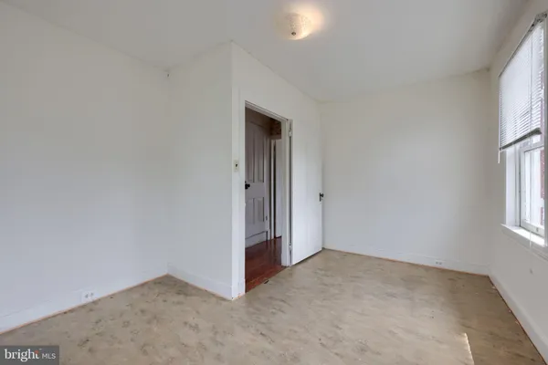 a front view of a house with a garden and plants