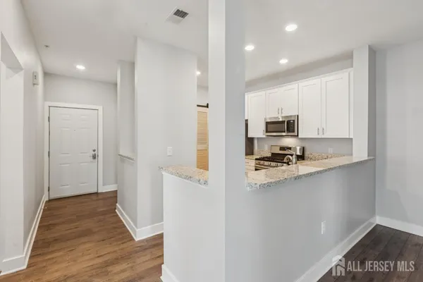 a kitchen with stainless steel appliances a refrigerator and cabinets