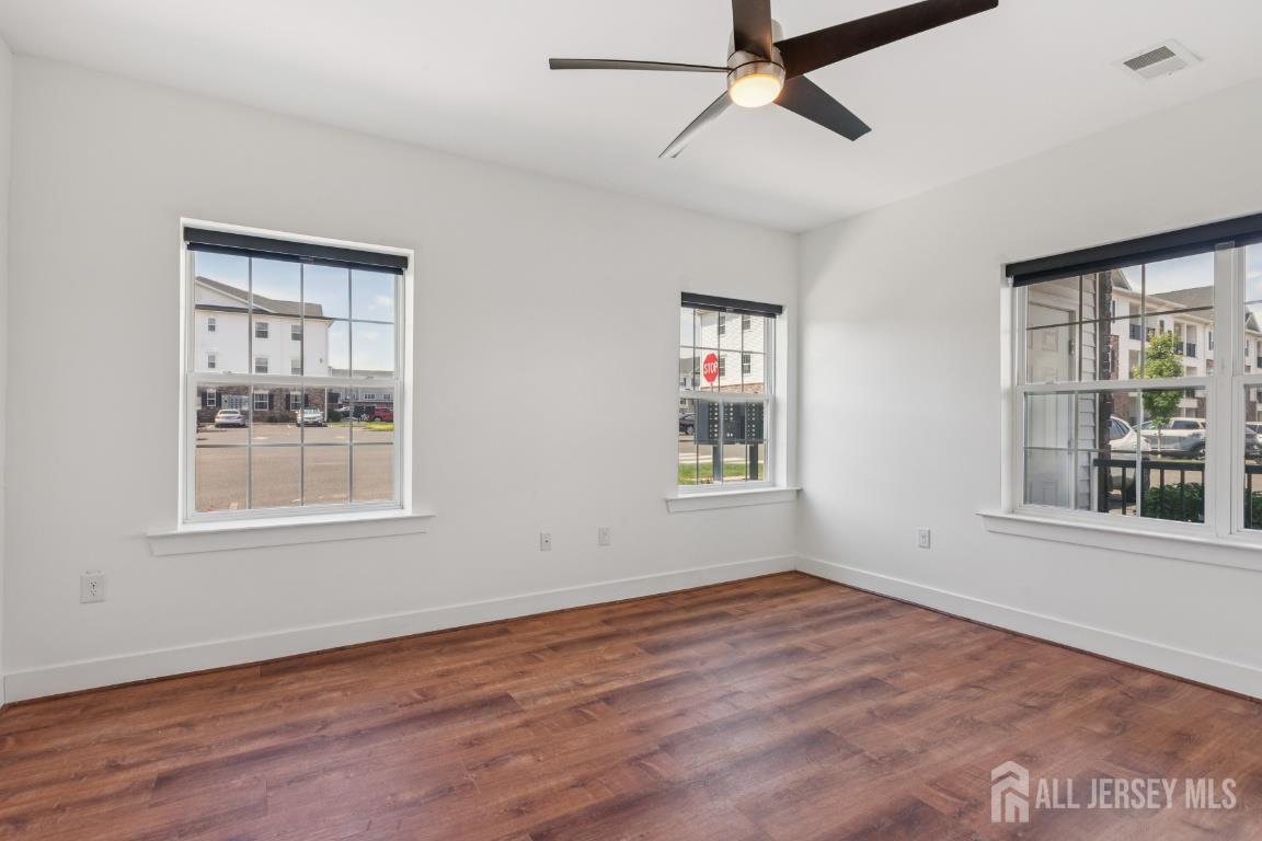 517 Tavern Road Monroe Township, NJ 08831 - Photo 22 of 27 a view of an empty room with a window and wooden floor