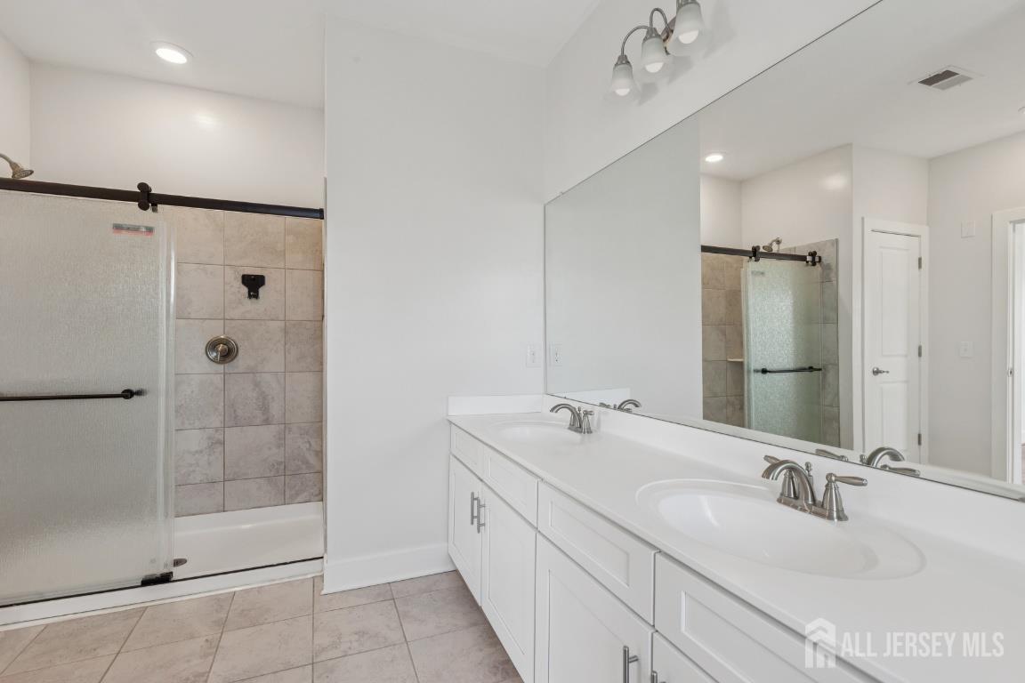 517 Tavern Road Monroe Township, NJ 08831 - Photo 25 of 27 a bathroom with a double vanity sink mirror and shower