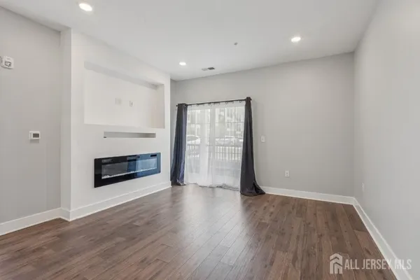 a view of a room with wooden floor and fireplace