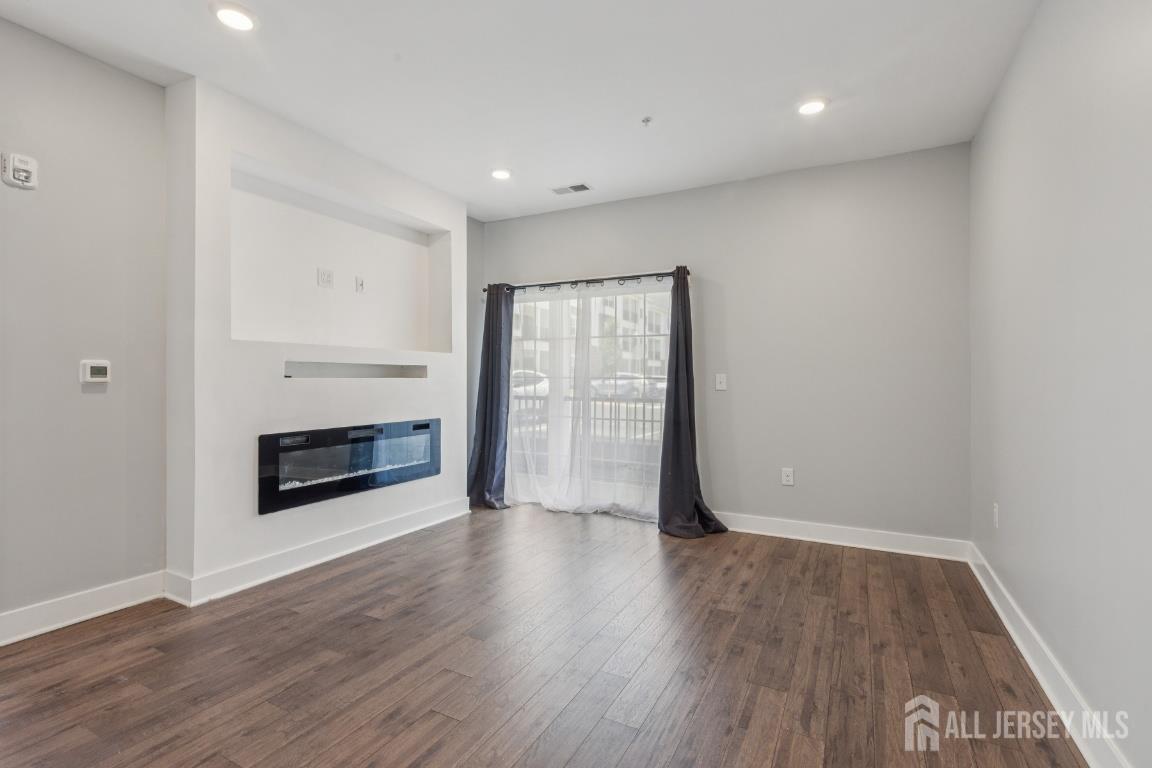 517 Tavern Road Monroe Township, NJ 08831 - Photo 3 of 27 a view of a room with wooden floor and fireplace