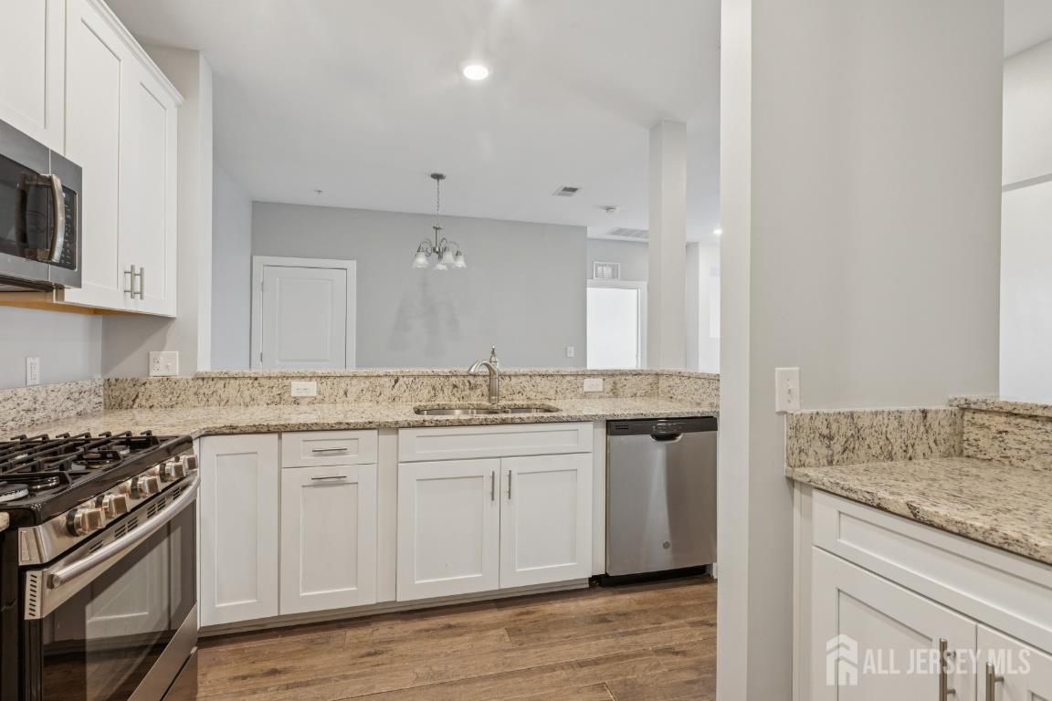 517 Tavern Road Monroe Township, NJ 08831 - Photo 5 of 27 a kitchen with stainless steel appliances granite countertop a stove and a sink