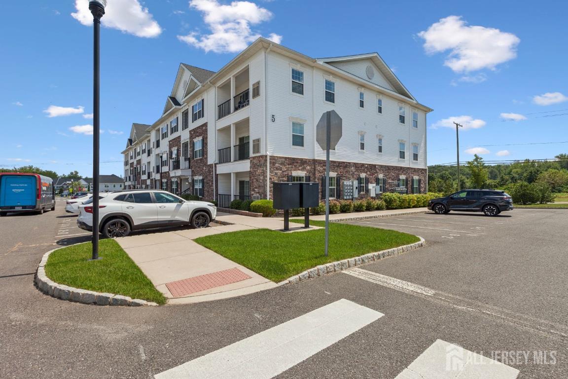 517 Tavern Road Monroe Township, NJ 08831 - Photo 6 of 27 a view of a building with a garden and car parked