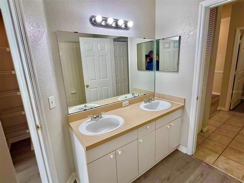 3751 Conroy Road, Unit 2334 Orlando, FL 32839 - Photo 7 of 20 a bathroom with a sink double vanity granite tub shower and a mirror