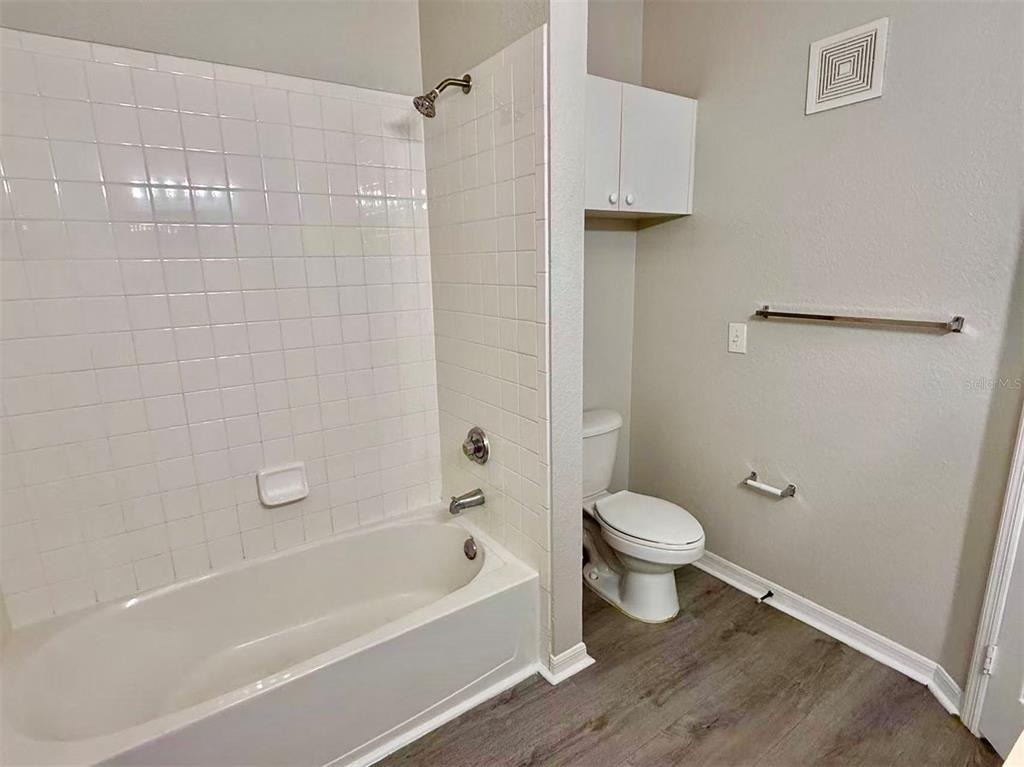 3751 Conroy Road, Unit 2334 Orlando, FL 32839 - Photo 9 of 20 a bathroom with a toilet and a bath tub