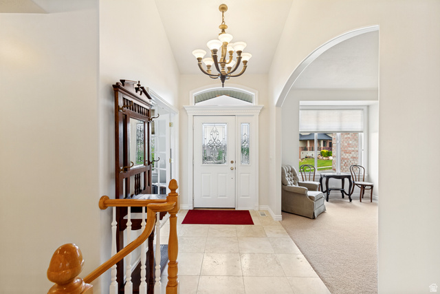 298 North Canyon Road Bountiful, UT 84010 - Photo 6 of 57 Inviting entryway featuring a leaded glass front door, transom window, and a decorative chandelier