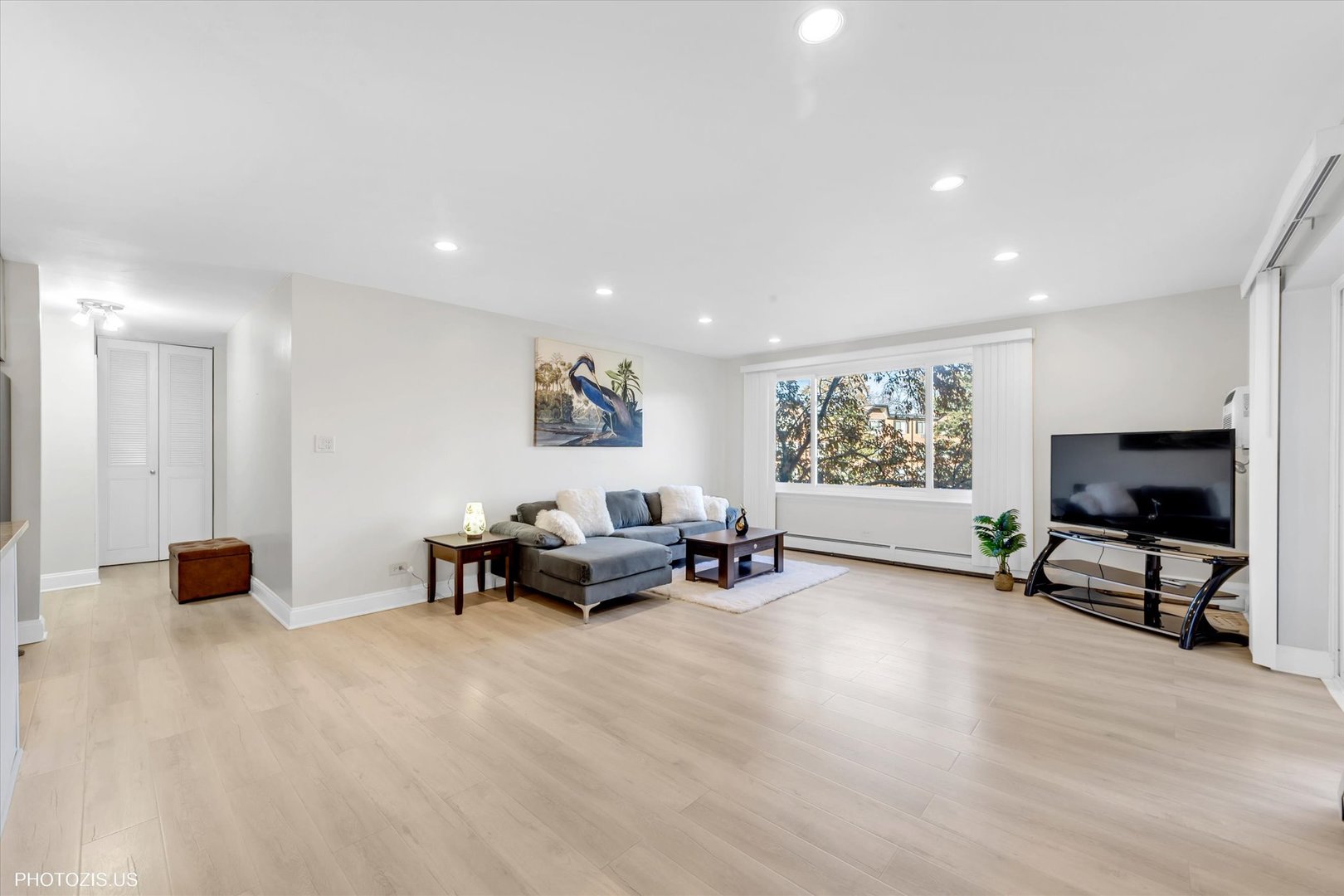 1126 South New Wilke Road, Unit 307 Arlington Heights, IL 60005 - Photo 7 of 37 a living room with furniture and a flat screen tv