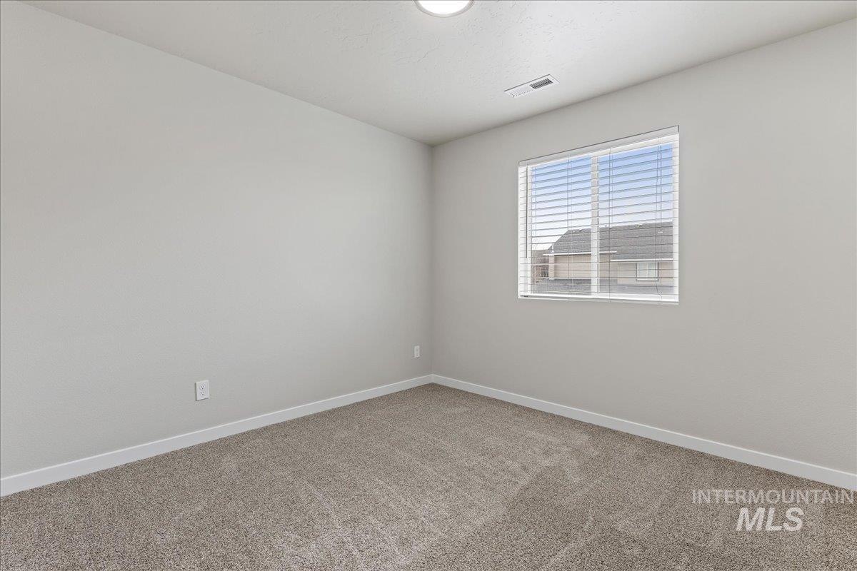 2479 East Goldstone Street Meridian, ID 83642 - Photo 15 of 29 Carpeted empty room featuring baseboards