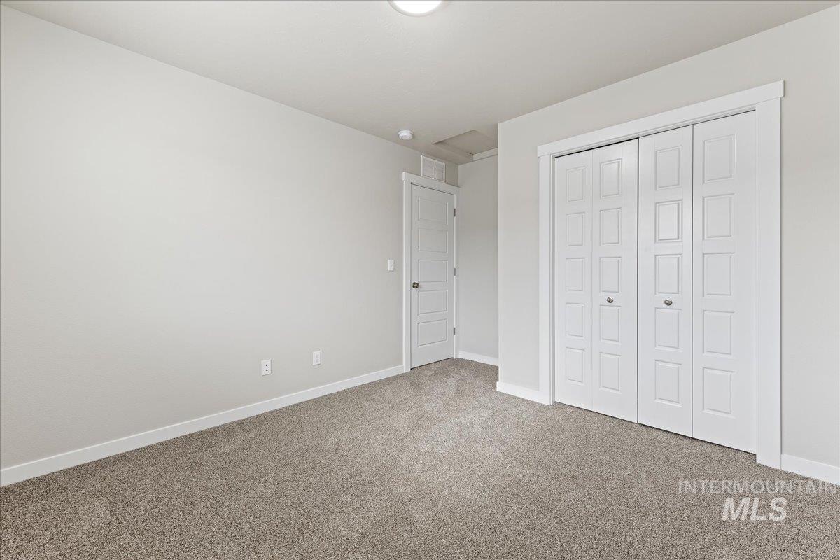 2479 East Goldstone Street Meridian, ID 83642 - Photo 16 of 29 Unfurnished bedroom featuring carpet floors and a closet