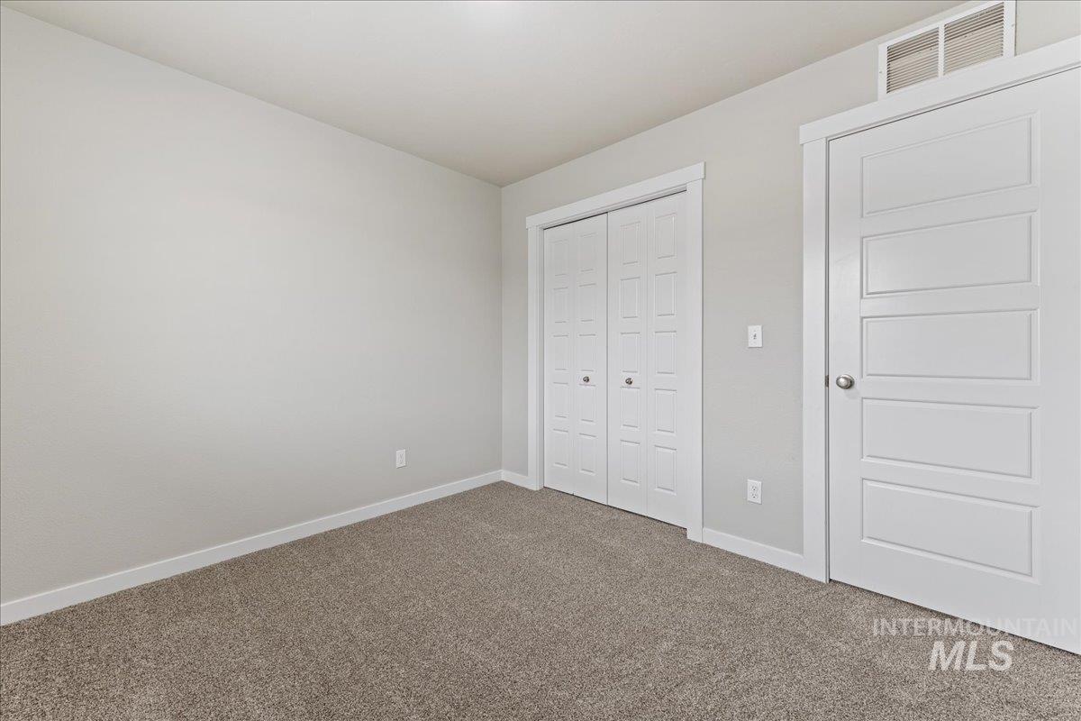 2479 East Goldstone Street Meridian, ID 83642 - Photo 18 of 29 Unfurnished bedroom featuring carpet flooring and a closet