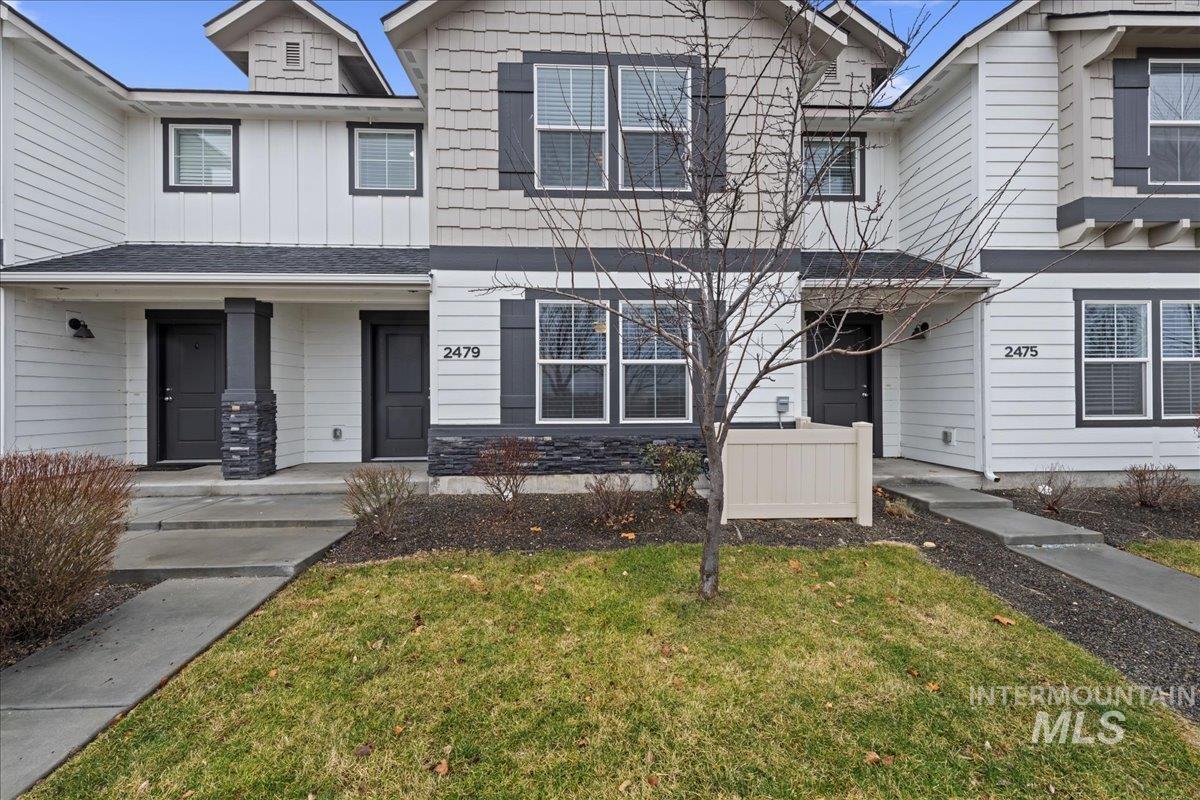 2479 East Goldstone Street Meridian, ID 83642 - Photo 2 of 29 View of front facade featuring board and batten siding, a front yard, and covered porch