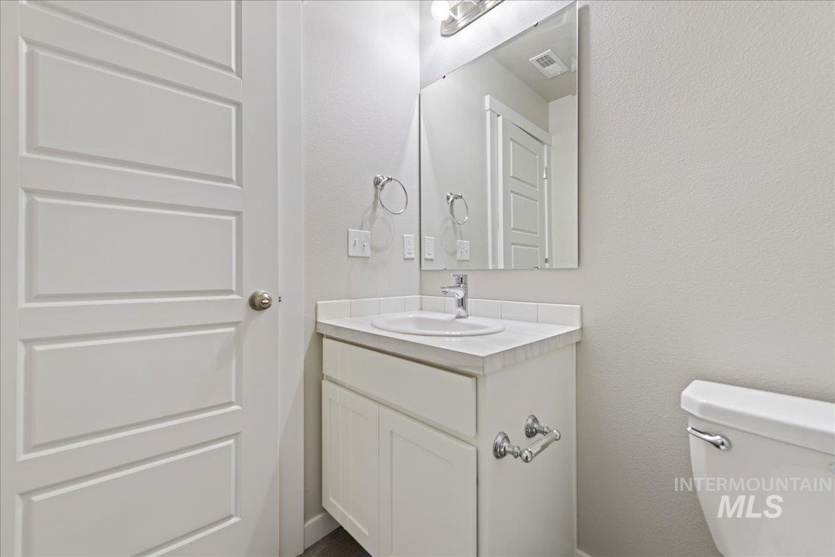 2479 East Goldstone Street Meridian, ID 83642 - Photo 22 of 29 Half bath with a textured wall and vanity
