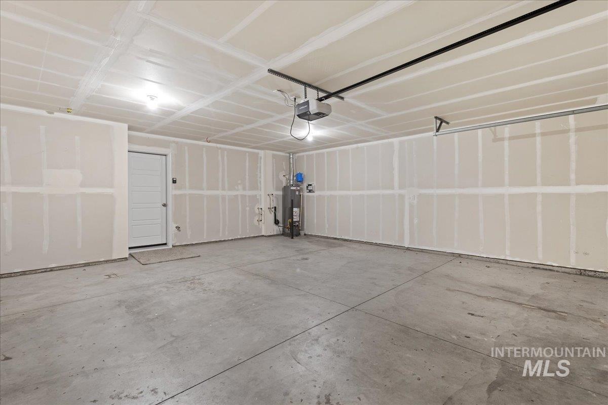 2479 East Goldstone Street Meridian, ID 83642 - Photo 25 of 29 Garage featuring gas water heater and a garage door opener
