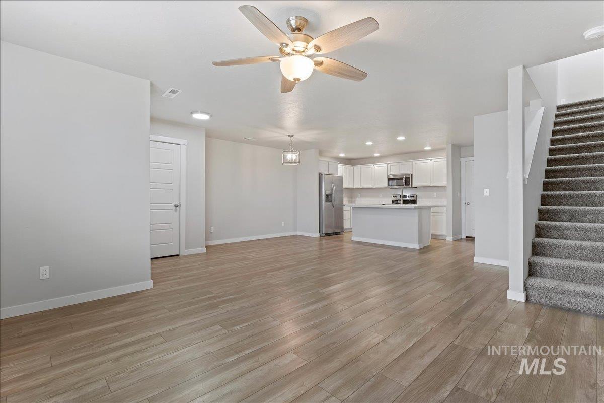 2479 East Goldstone Street Meridian, ID 83642 - Photo 7 of 29 Unfurnished living room with recessed lighting, ceiling fan, and light wood-style flooring