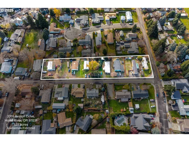 a view of a street with a cars parked on the road