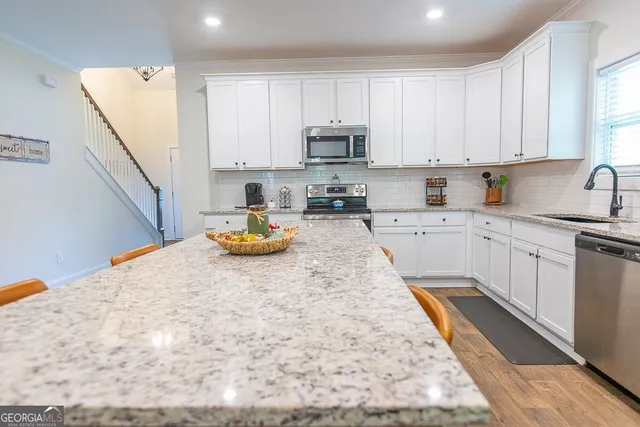 a open kitchen with cabinets stove and wooden floor
