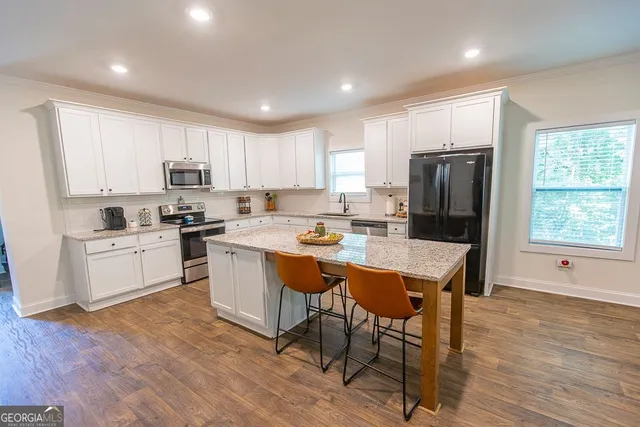 a living room with furniture fireplace and wooden floor