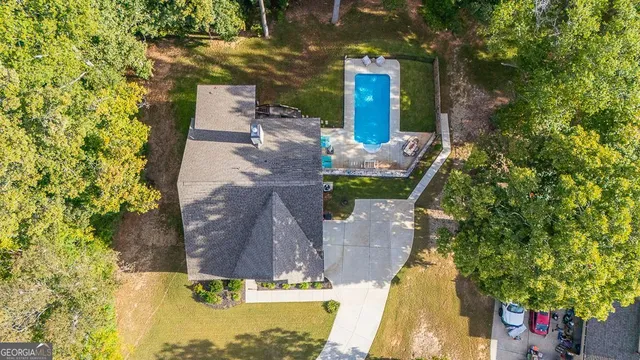 a kitchen with stainless steel appliances granite countertop a refrigerator a sink dishwasher a stove top oven a refrigerator with white cabinets and wooden floor