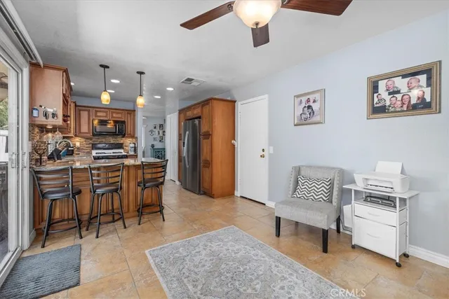 a living room with furniture and kitchen view