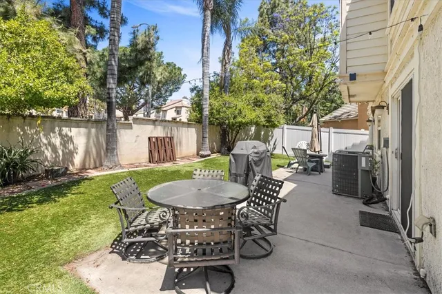 a view of a patio with table and chairs and potted plants