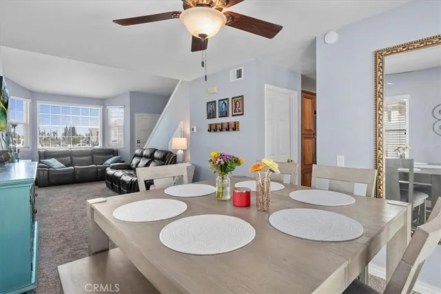 a dining room with furniture and a chandelier
