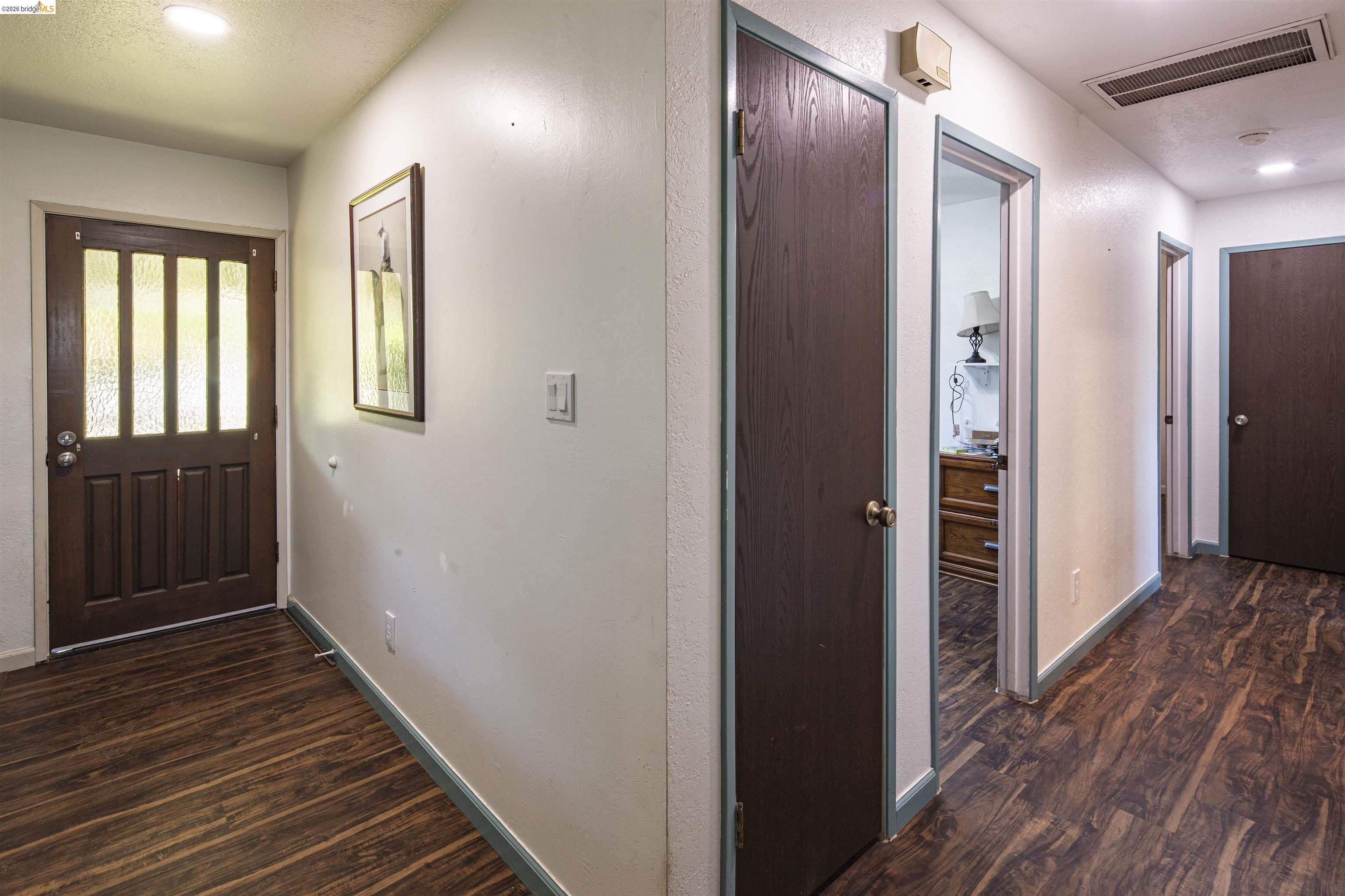 10458 Southworth Road Valley Springs, CA 95252 - Photo 12 of 22 Hallway with recessed lighting and dark wood-type flooring