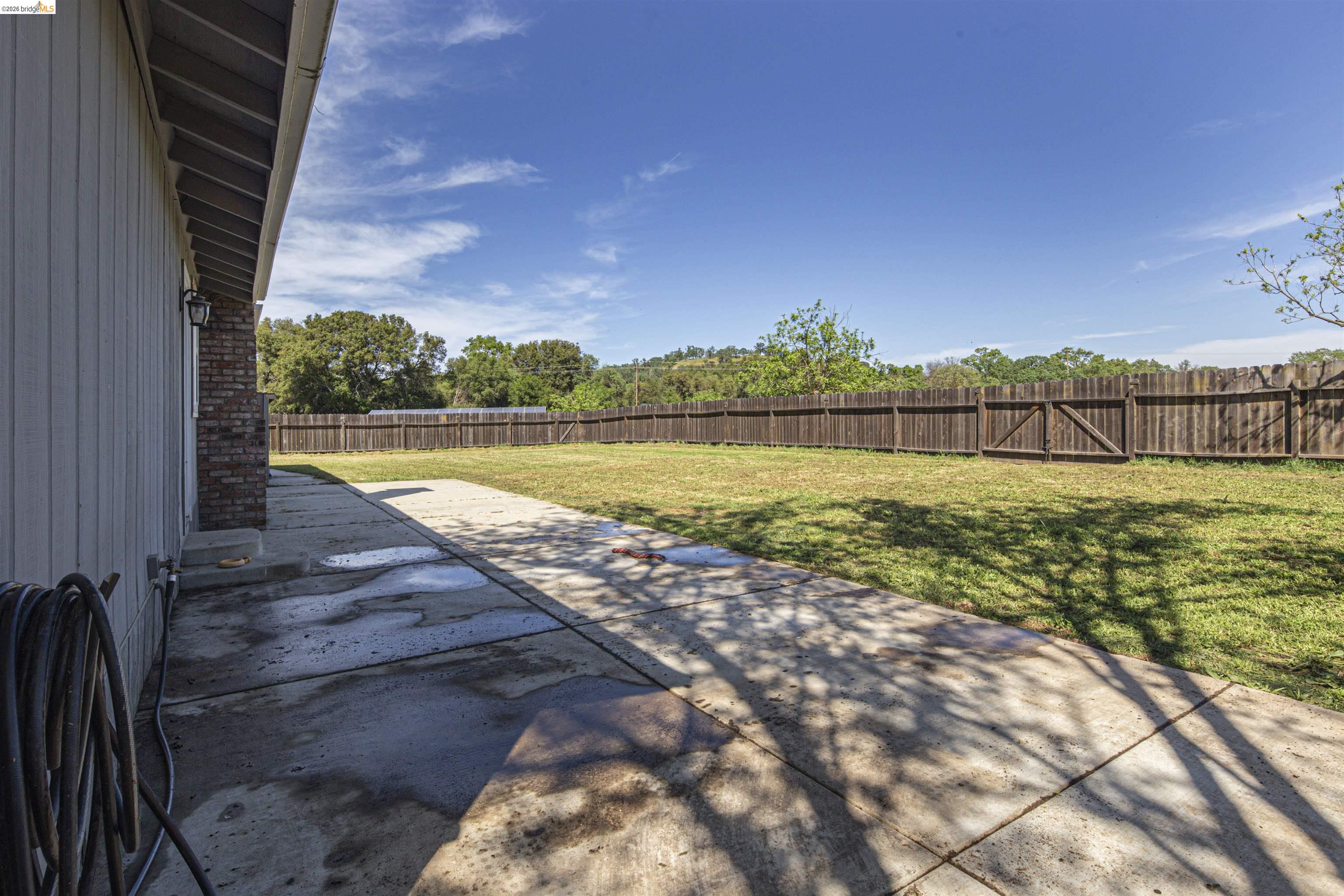 10458 Southworth Road Valley Springs, CA 95252 - Photo 18 of 22 Fenced backyard with a patio